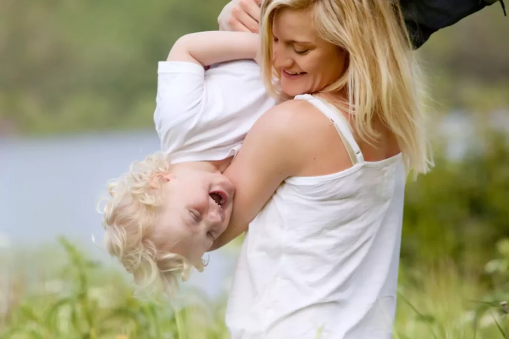mother and son wrestling and laughing as mom speaks her child's love language