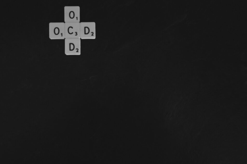 letter tiles spelling out "OCD" for obsessive-compulsive disorder