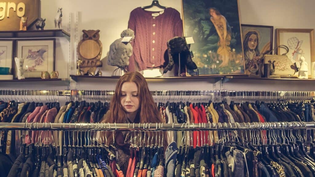 teen girl in thrift clothing shop