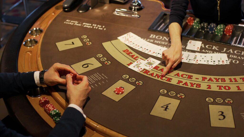 gambling table dealer and player hands