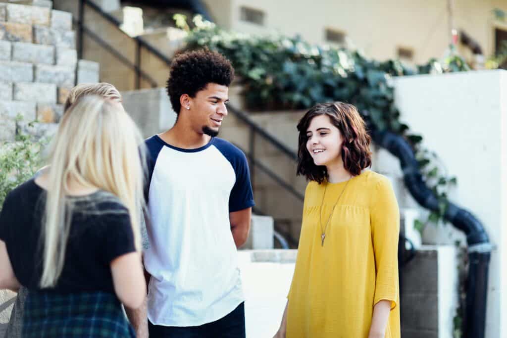 two teen girl and boy talking