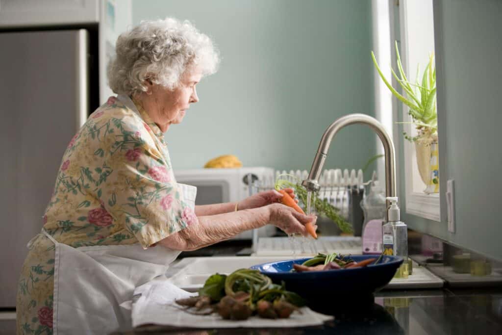 Older woman working in kitchen