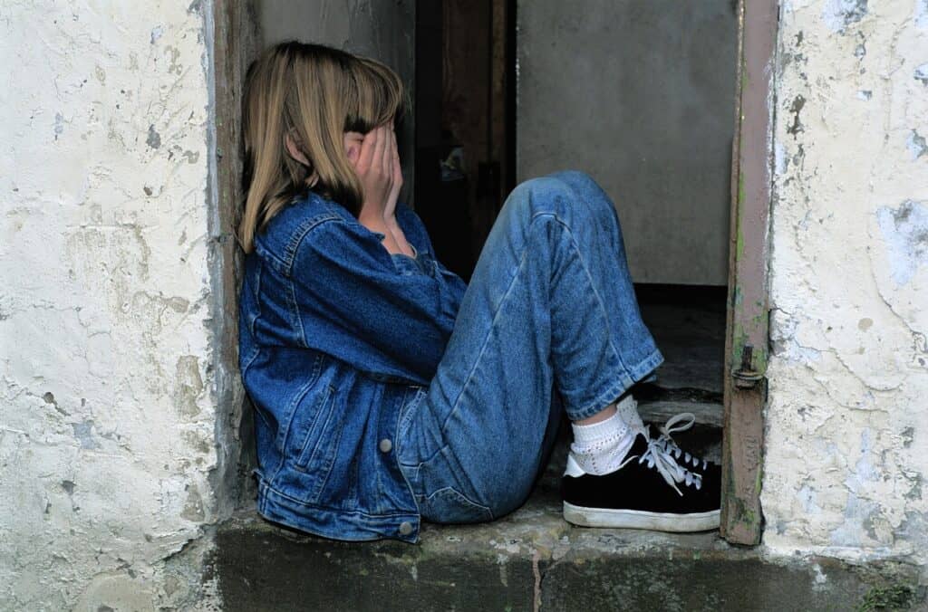 Girl covering face with hands