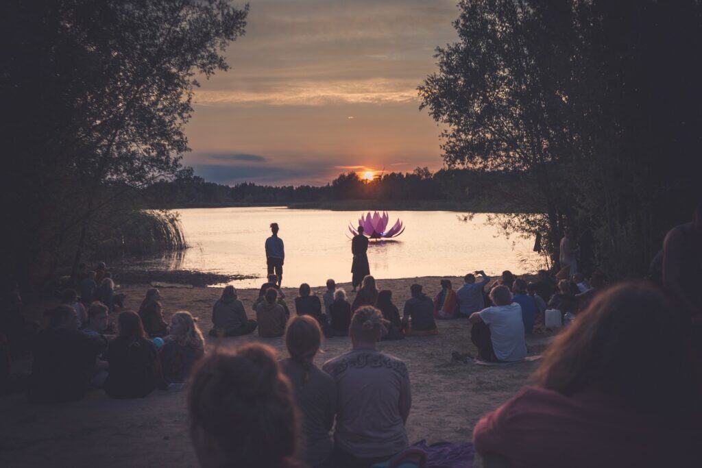 large group sitting by lake
