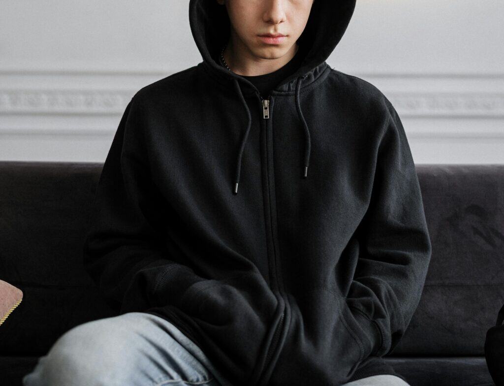 teen boy in hoodie hands in pockets