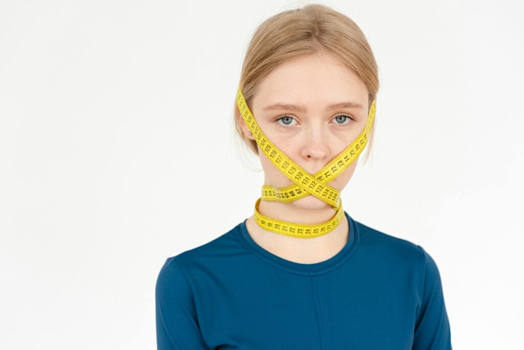 thin woman tape measure wrapped around head