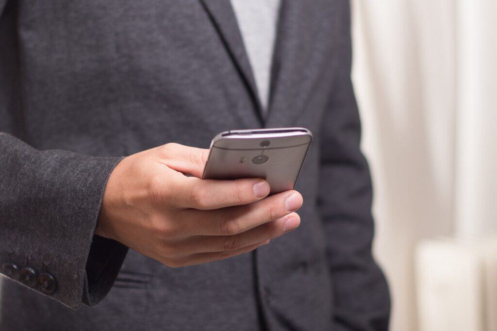 man in suit phone in hand