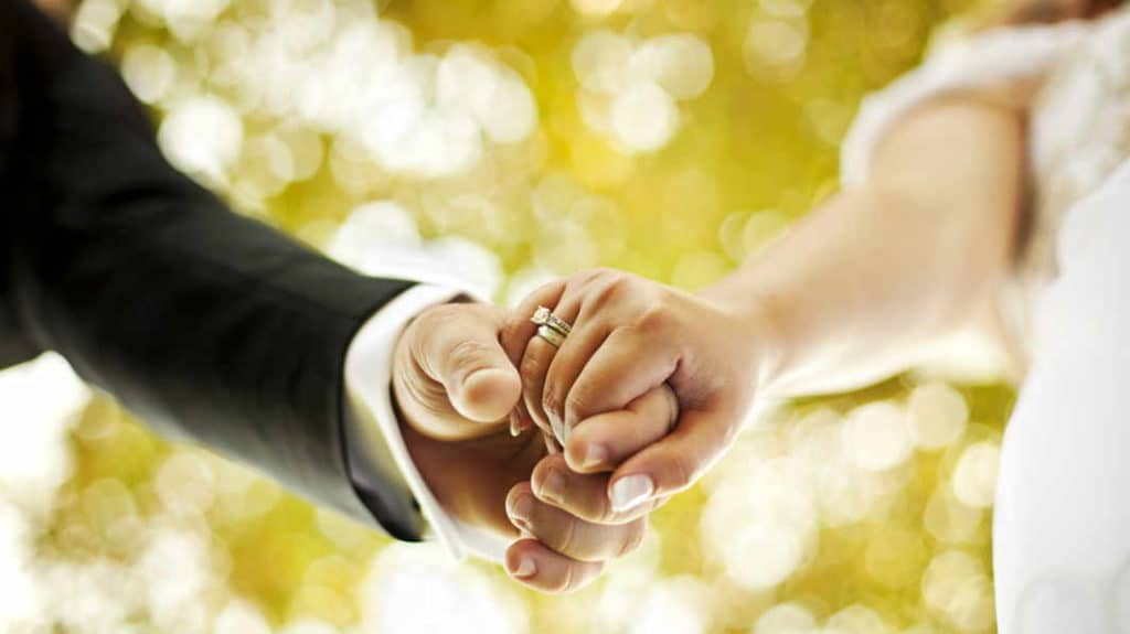 Newlyweds holding hands