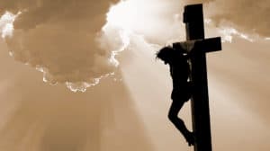 Jesus on the cross silhouette brown background.
