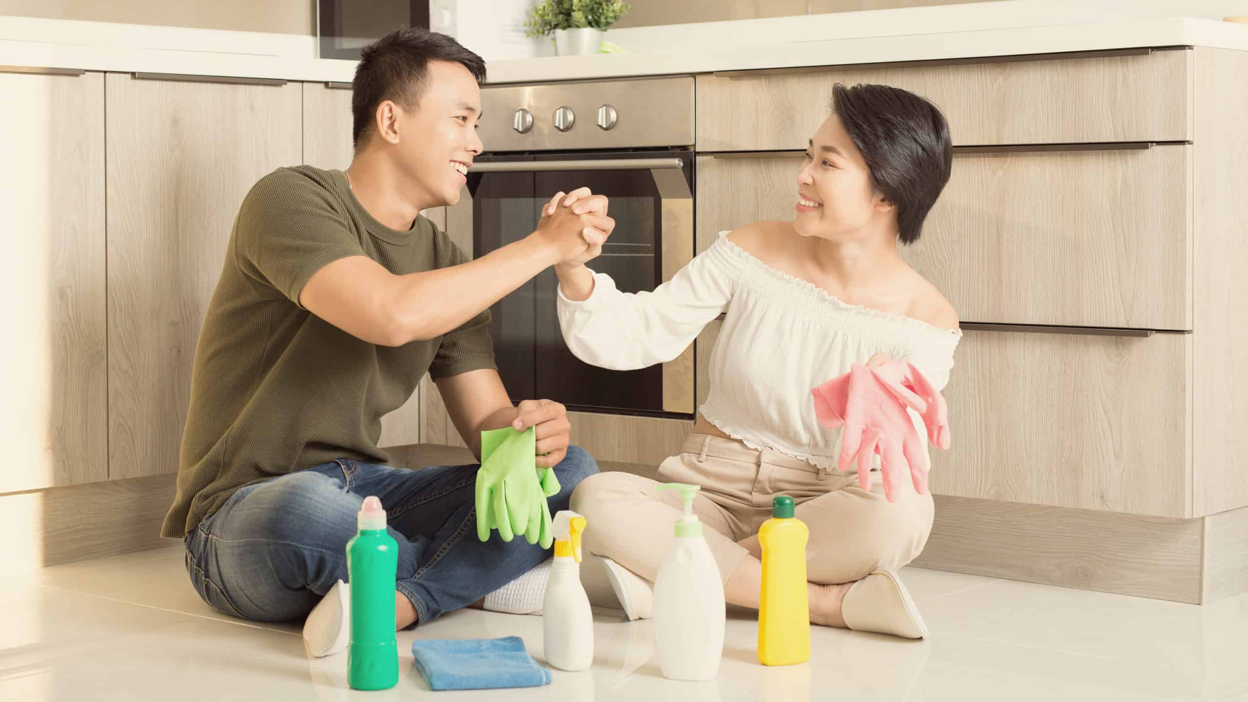 a couple cheers each other on while doing chores