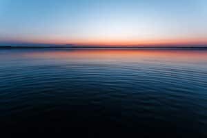 Circles on the water against a beautiful, pink sunset. The magic time of day.