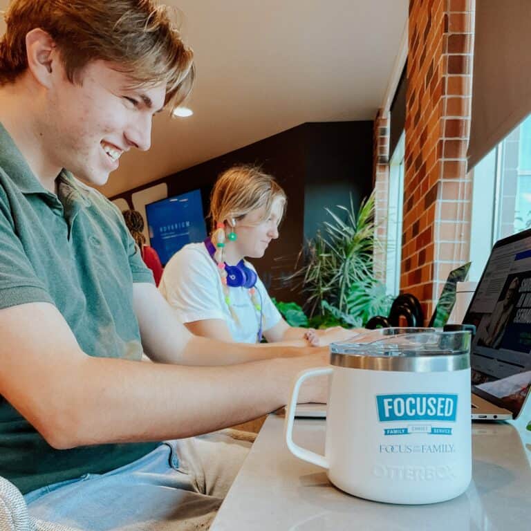 Interns working together on computers